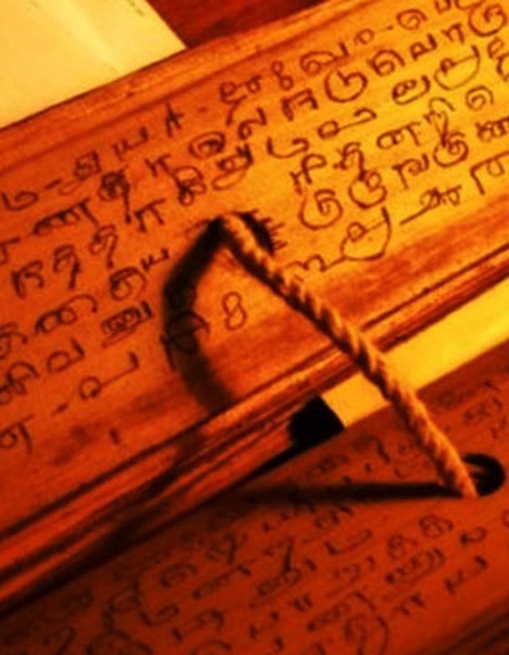 A bound palm-leaf manuscript inscribed in old Tamil script